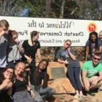 Students gathered in front of a sign